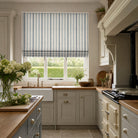 Plano Blue Grey striped linen curtain fabric shown as a Roman blind, relaxed stripe fabric for calm interior schemes