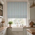 Plano Blue striped linen curtain fabric shown as a Roman blind, soft blue stripe fabric for window treatments and cushions