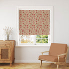 Rust Orange Poppy linen Roman blind showing a warm floral curtain fabric in a styled interior