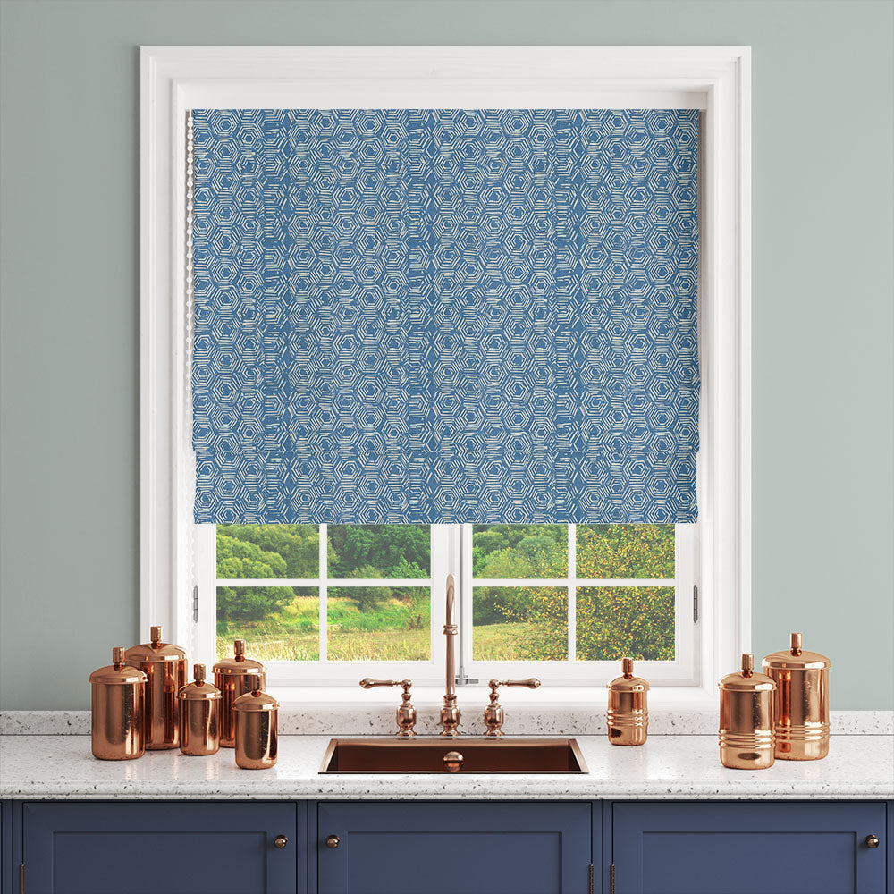 Geometric curtain fabric with blue hexagonal pattern shown as a Roman blind