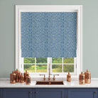 Geometric curtain fabric with blue hexagonal pattern shown as a Roman blind