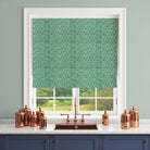 Green geometric curtain fabric used for a modern blind in a bright interior
