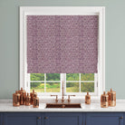 Purple geometric curtain fabric shown as a blind above a copper sink