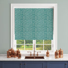 Teal geometric curtain fabric styled as a blind in a kitchen setting