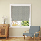 Rowan Leaf Blue linen Roman blind showing the repeating botanical tree design at a window