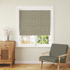 Rowan Leaf Olive patterned Roman blind styled with warm wood and relaxed country interiors