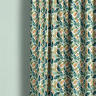 Salcey washable curtain fabric shown as botanical curtains with green, blue and ochre leaves