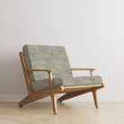 Armchair upholstered in green wave style upholstery fabric with coastal inspired texture