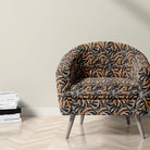 Siberian tiger print velvet fabric on upholstered chair with pale animal stripe design