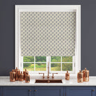 Navy blue paisley curtain fabric styled as a Roman blind in a traditional interior