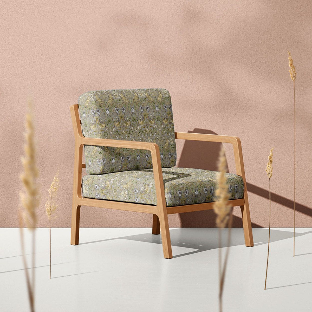 Grey Strawberry Thief fire retardant velvet upholstery fabric on a contemporary armchair
