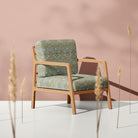 Nordic Strawberry Thief fire retardant velvet fabric on a soft neutral armchair