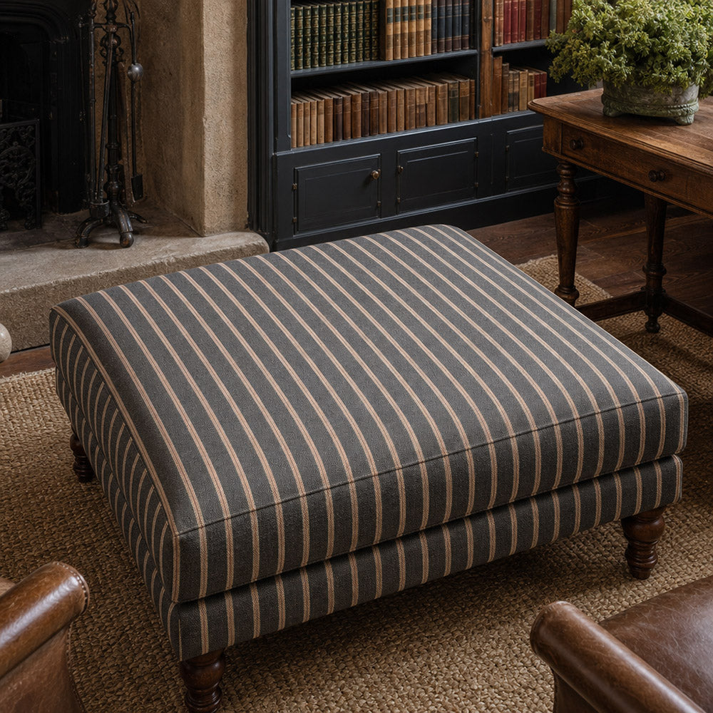 Suffolk Charcoal striped upholstery fabric shown on a stool, dark stripe fabric for heavy duty domestic upholstery