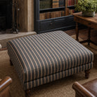 Suffolk Charcoal striped upholstery fabric shown on a stool, dark stripe fabric for heavy duty domestic upholstery