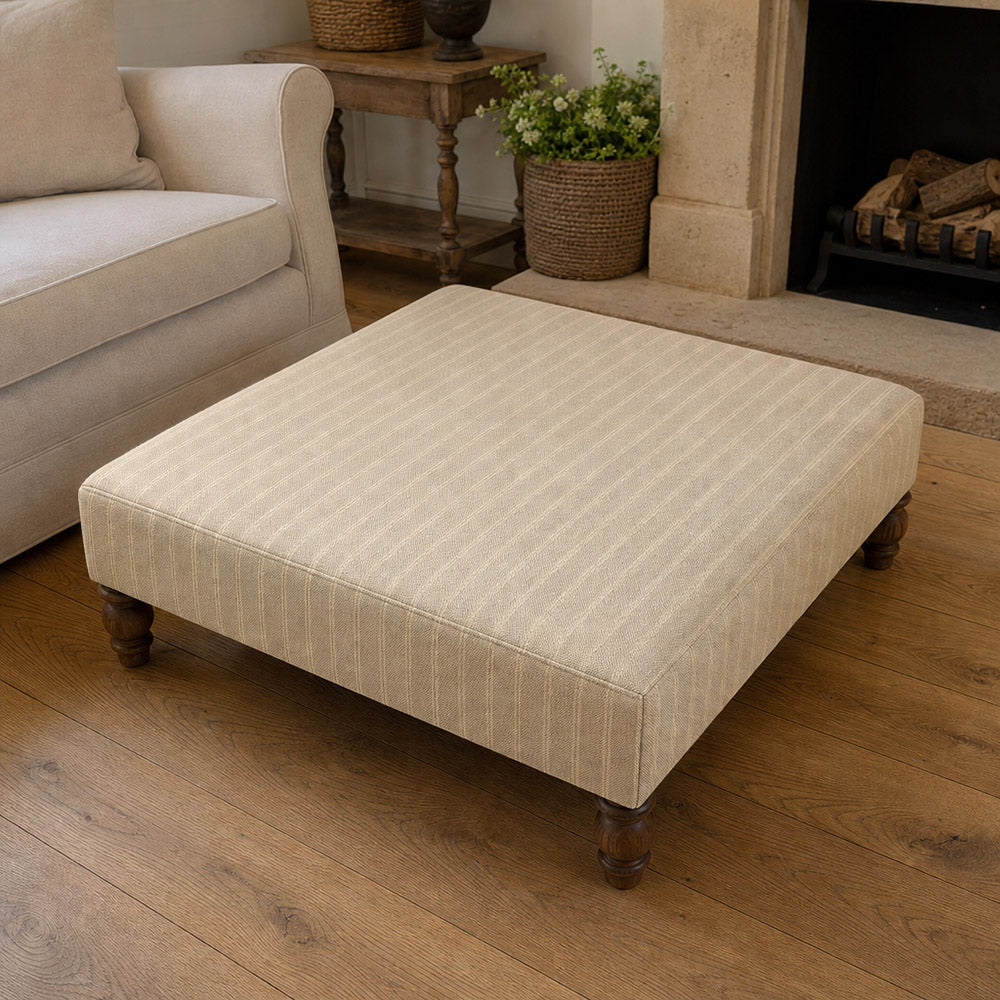 Suffolk Natural striped upholstery fabric shown on a stool, neutral cotton-linen stripe fabric for classic upholstery