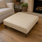 Suffolk Natural striped upholstery fabric shown on a stool, neutral cotton-linen stripe fabric for classic upholstery