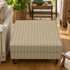 Suffolk Straw striped upholstery fabric shown on a stool, soft neutral stripe fabric for upholstered seating and cushions