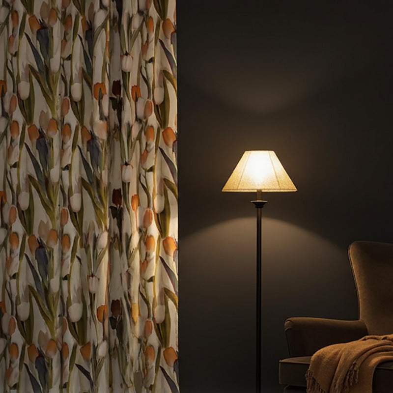 Bold tulip floral curtain fabric in a moody interior with dark walls and soft floor lighting
