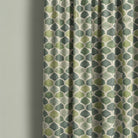 Verdant Leaf Linen Curtain – draped green leaf curtain fabric on pale green wall