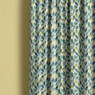 Whinfell washable leaf fabric displayed as blue-green botanical curtains in a calm interior