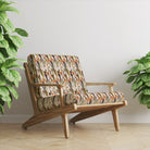 Wild Flower Crib 5 velvet upholstery fabric shown on a chair with orange floral pattern