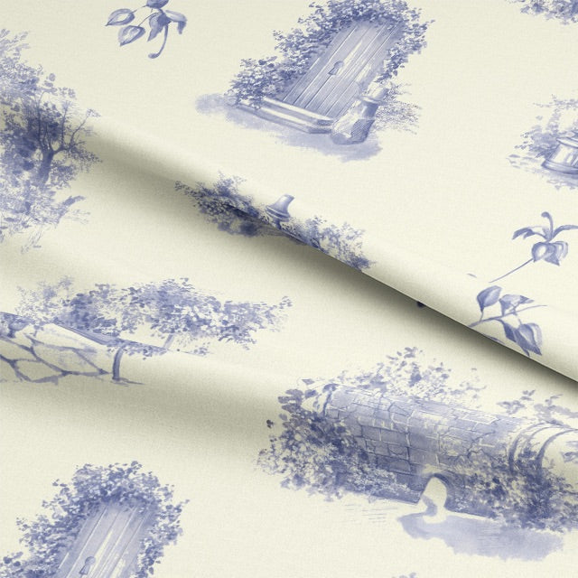  A folded piece of Aquitaine Toile Cotton Curtain Fabric in Blue Ivory, displaying its elegant blue and ivory color combination
