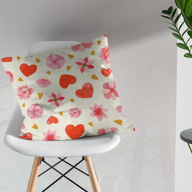 Red cotton fabric featuring charming hearts and flowers, a lovely choice for adding warmth and character to any room