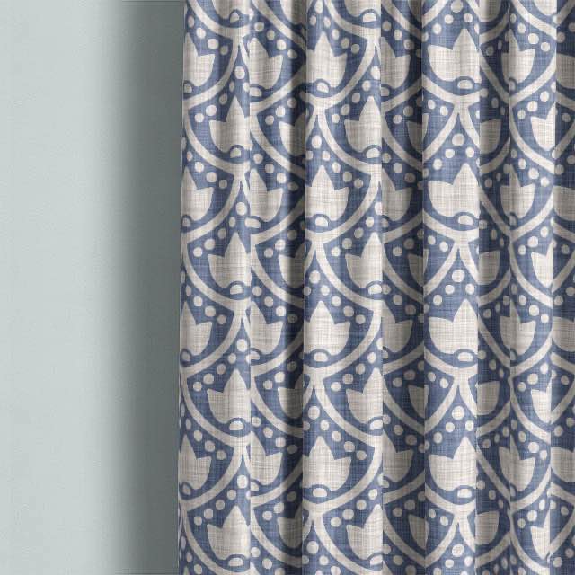 Beautiful Lanivet Cotton Curtain Fabric - Blue hanging in a bedroom window with natural light shining through