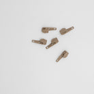 Mediumweight Zippers Beige - Beige zip heads for mediumweight chain zipping