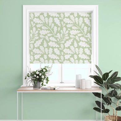  Sage Green Cotton Curtain Fabric with Oak Leaf design, hanging in a sunny room, creating a warm and inviting atmosphere